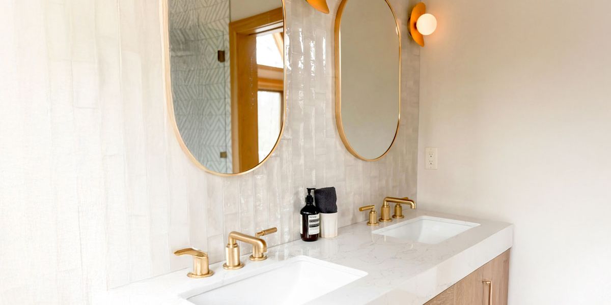 A modern bathroom featuring two sinks and two mirrors, designed for shared use.